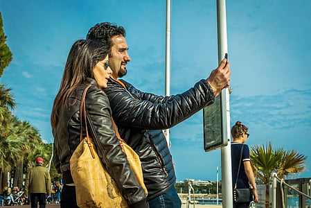 man and woman taking selfie thumbnail