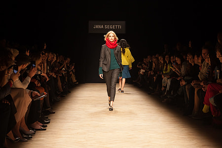 woman walking between people thumbnail