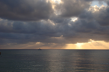 ship on body of water under clouds thumbnail