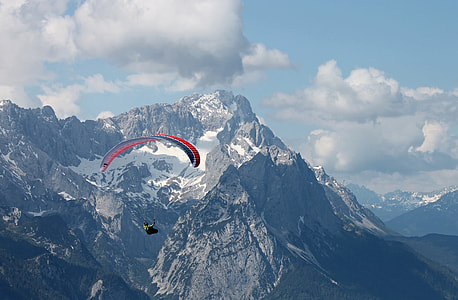 man in parachute near mountain covered with snows thumbnail