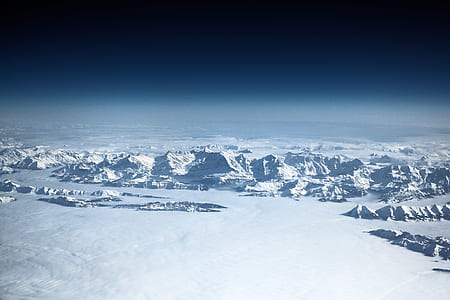 aerial photography of snow cap mountains near bodies of water at daytime thumbnail