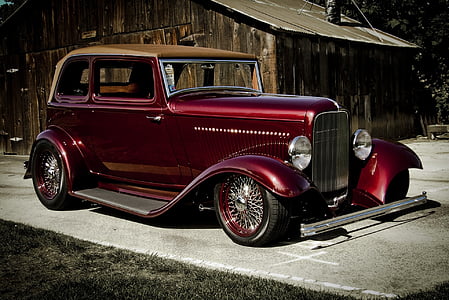 red vehicle near brown shed thumbnail