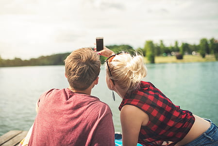 man and woman taking picture during daytime thumbnail