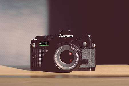 black Canon camera on top of brown wooden surface thumbnail