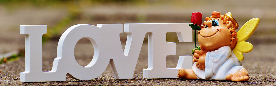 white love free standing letter and figurine holding red rose thumbnail