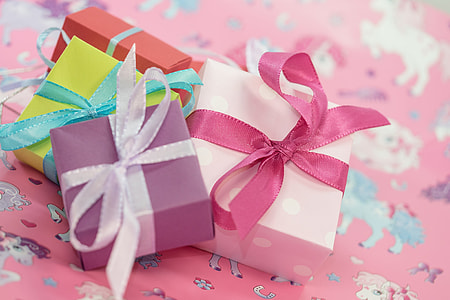 four assorted-color gift boxes on surface thumbnail