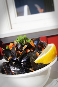 seafood dish in white bowl with sliced lemon thumbnail