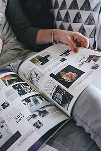 Woman reading a designer magazine on a couch thumbnail