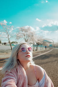 woman wearing silver framed hippie sunglasses and pink bathrobe thumbnail