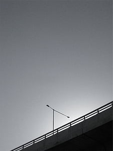 gray concrete bridge under cloudy sky thumbnail