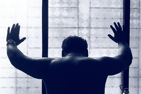 topless man leaning on wall glass wall thumbnail