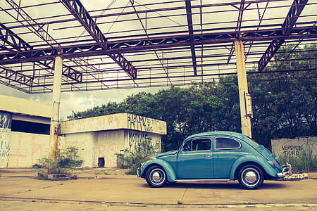 Blue Volkswagen Beetle in Front of Building thumbnail