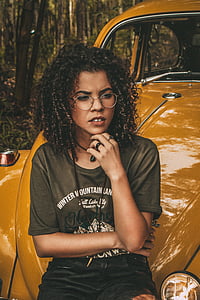 woman in brown shirt sitting on vaulkswagen beetle thumbnail