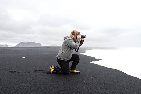 man taking photo near seashore thumbnail