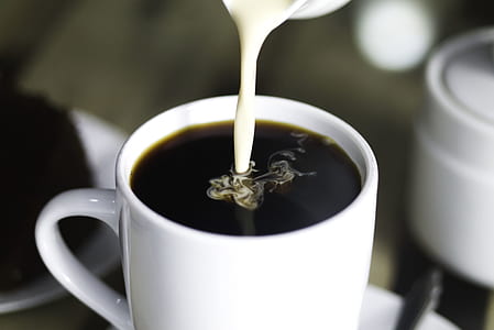 ceramic cup filled with coffee and creamer thumbnail