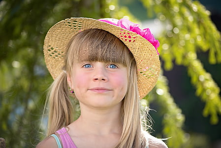 girl in pink shirt wearing brown hat thumbnail