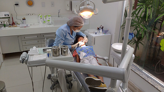 dentist cleaning a boys teeth thumbnail