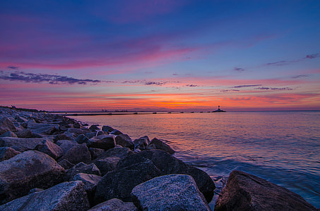 landscaped photography of body of water and rocks thumbnail