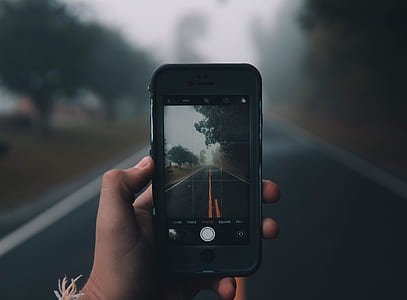 person taking photo of foggy road thumbnail