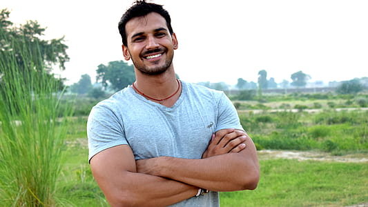 man standing on grass and smiling thumbnail