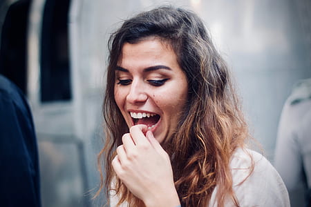 woman laughing holding her teeth thumbnail