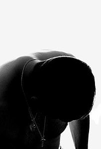 silhouette of nodding man wearing necklaces thumbnail