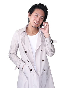 man in gray trench coat using mobile phone thumbnail