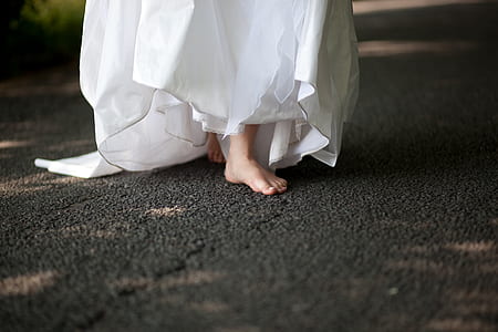 woman wearing white dress walking on black area rug thumbnail