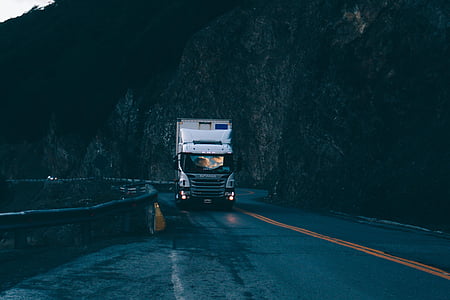 white and black semi-trailer truck on road cliff thumbnail