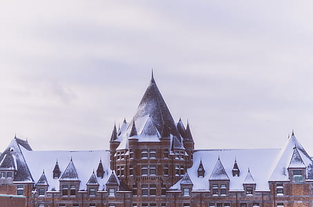 brown concrete building covered by snow thumbnail