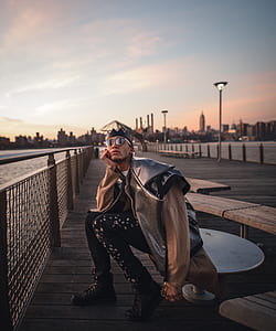 man sitting on table nearby fence thumbnail
