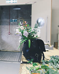 assorted flowers on black leather backpack thumbnail