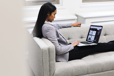 Woman With Laptop On Couch Photo thumbnail