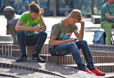 two man sitting holding phone thumbnail