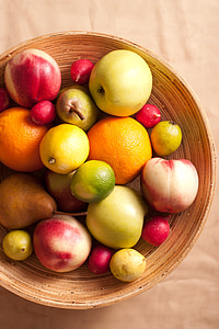 closeup photography of apple fruits, orange fruits, pear fruits, and lemons in brown rattan bowl thumbnail
