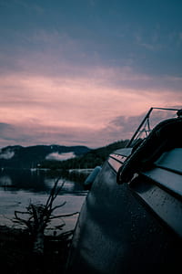 black textile above boat on calm body of water thumbnail