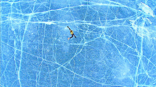 bird's-eye view photography of person skiing in the frozen lake thumbnail