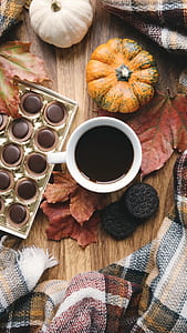 white ceramic mug near pumpkin thumbnail