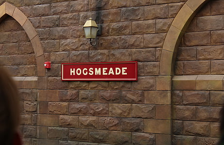 red Hogsmeade signage on brick wall thumbnail