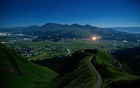 aerial photography of road to a city under blue sky thumbnail