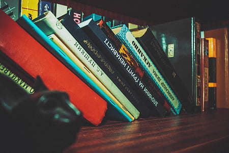 assorted books on brown wooden desk-top thumbnail