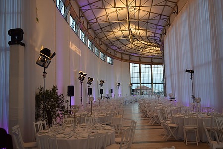 white table clothes with chairs set inside dome building thumbnail