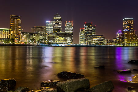 Body of Water Across City Buildings during Night thumbnail