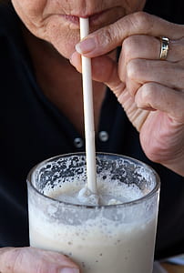 person holding clear drinking glass thumbnail
