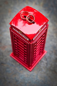 red and gray telephone booth coin bank and two silver-colored rings thumbnail