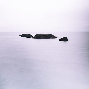 black rock on body of water thumbnail