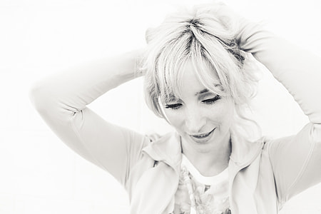 closeup photo of woman wearing jacket tying her hair thumbnail