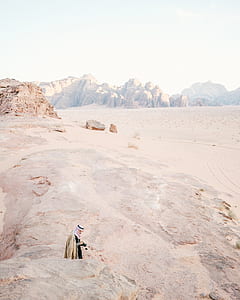 man standing on desert under blue sky during daytime thumbnail