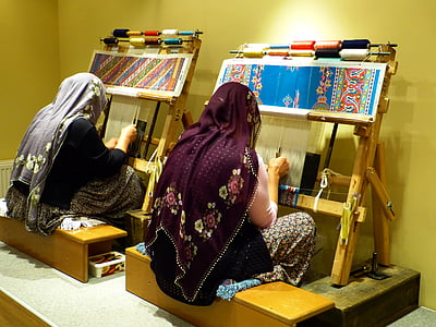 two woman wearing shawls weaving thumbnail