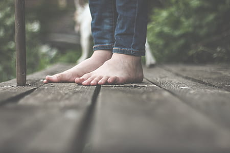 person wearing blue denim jeans standing on the floor thumbnail